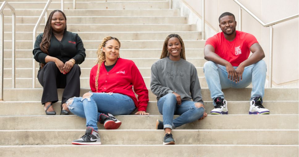 亚洲博彩网站 Law 学生 sitting on staircase.